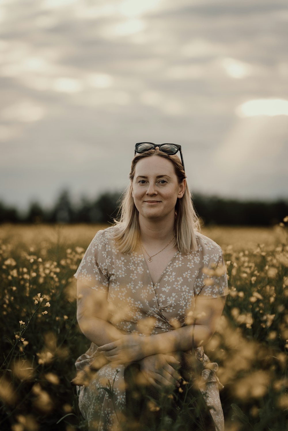 a woman standing in a field of flowers