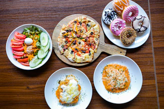 A vibrant spread of pizza slices, fresh salads, and colorful desserts at the buffet.