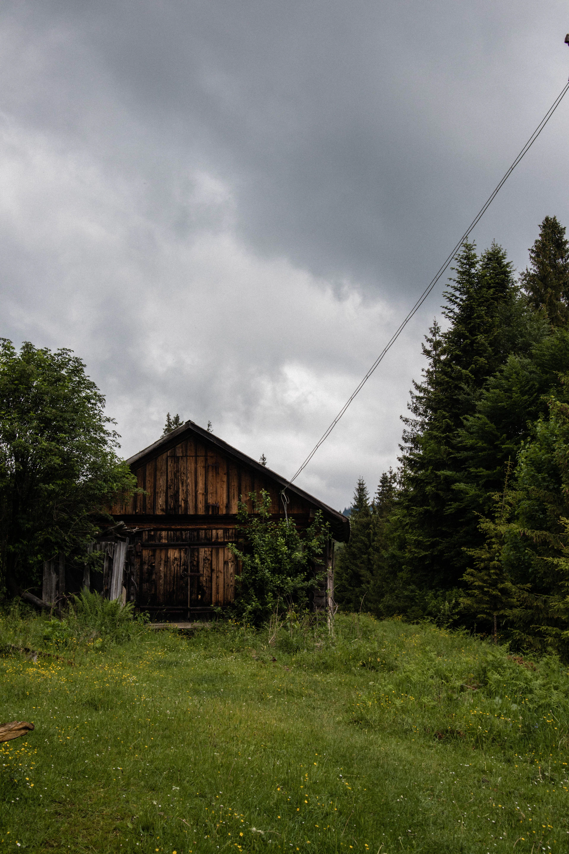 a wooden building in a field