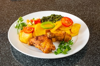 Assorted chicken cuts including thighs, livers, and hearts on a clean white platter.