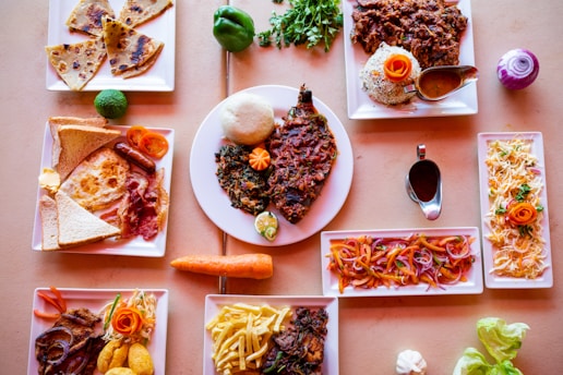 A colorful spread of international dishes arranged on a rustic wooden table, inviting a global culinary journey.