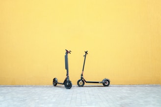 a couple of wheeled scooters