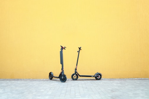 a couple of wheeled scooters