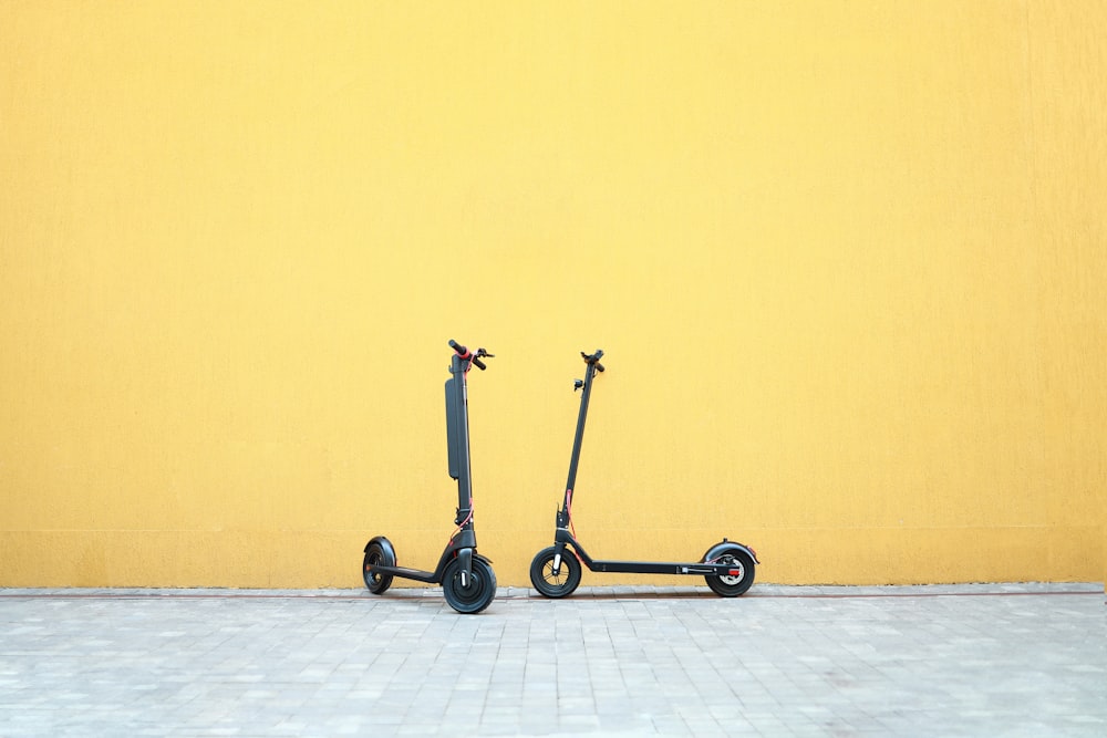 a couple of wheeled scooters
