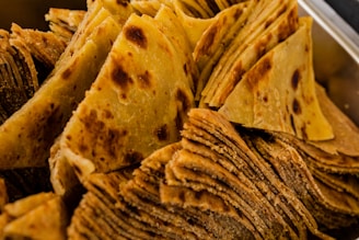 A stack of warm, fluffy rotis wrapped in a cloth, ready for delivery.