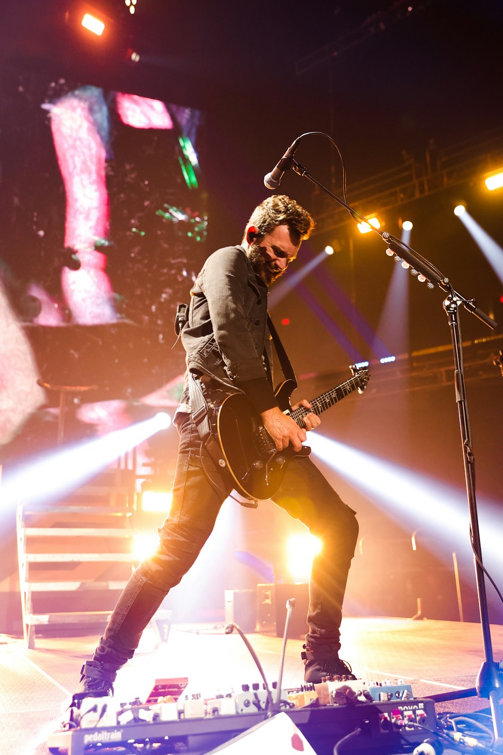 a man playing a guitar on a stage