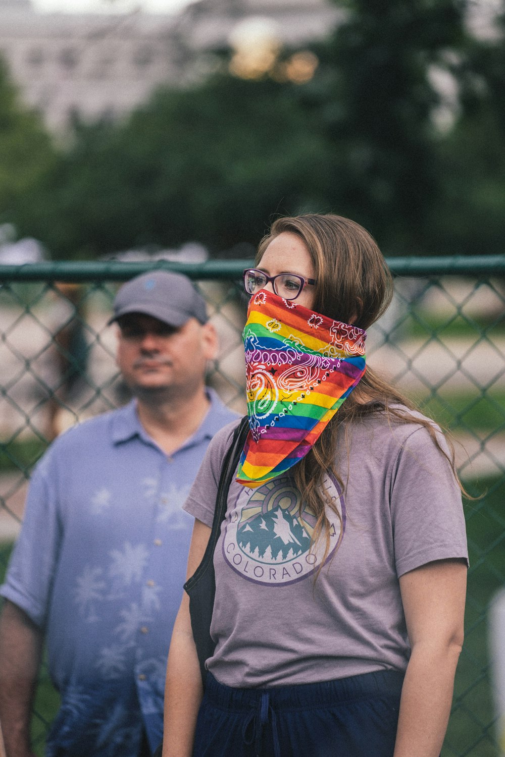 a man and woman with a rainbow pinata