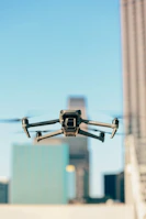 A picturesque urban rooftop showing several švaros sparnas drones lined up, ready for the day's cleaning missions.