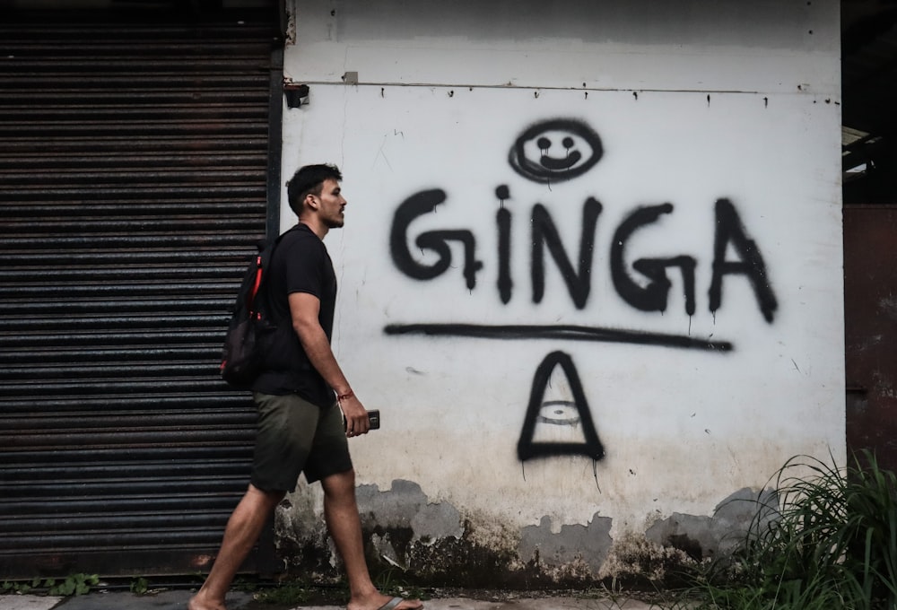 a man walking by a sign