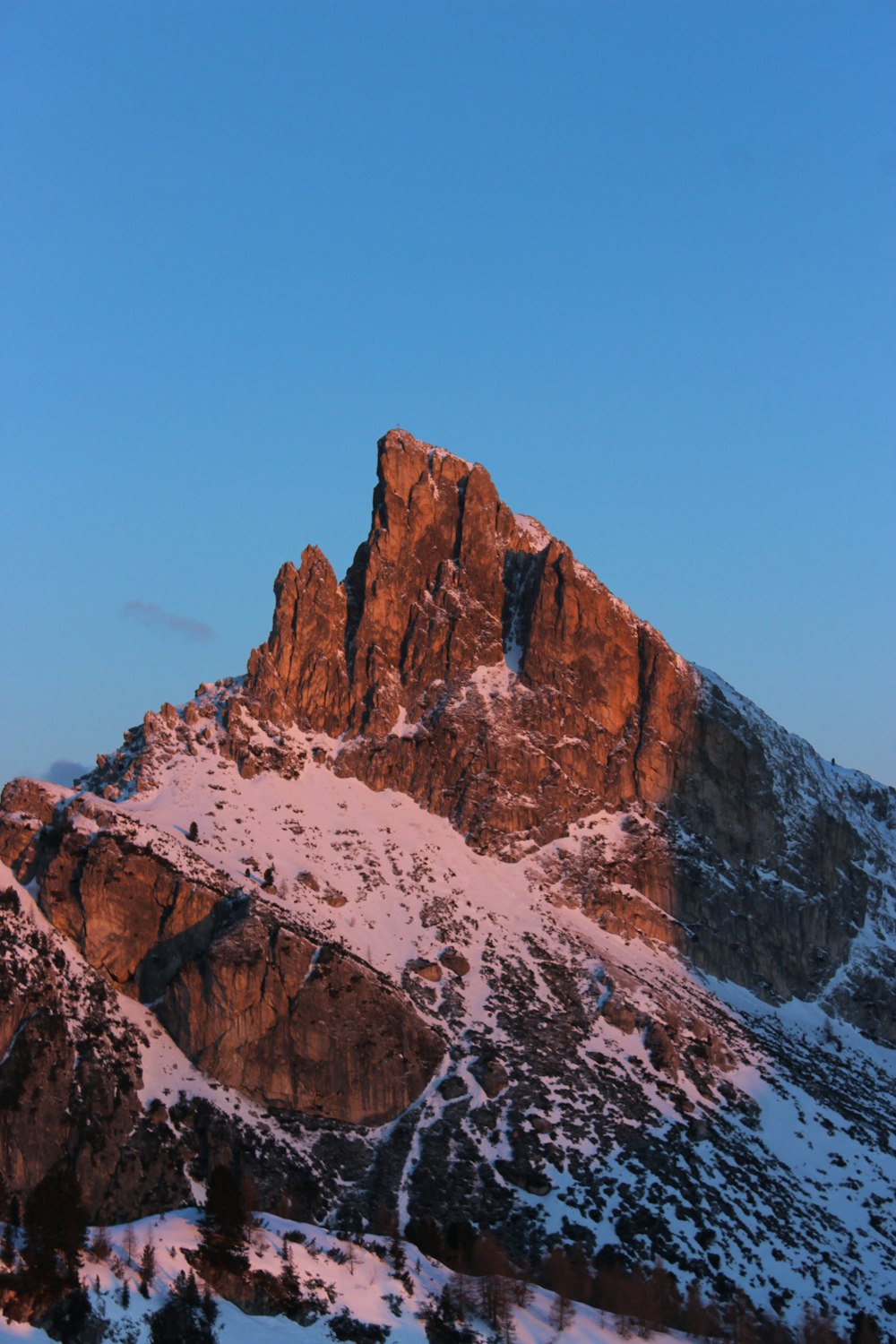 a snowy mountain with a blue sky