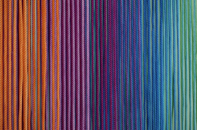 Color-changing yarn transformation captured mid-process with vibrant hues.