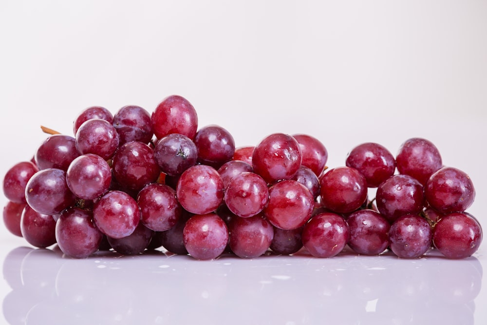 a bowl of red grapes