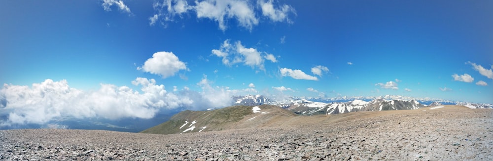 a rocky landscape with snow covered mountains