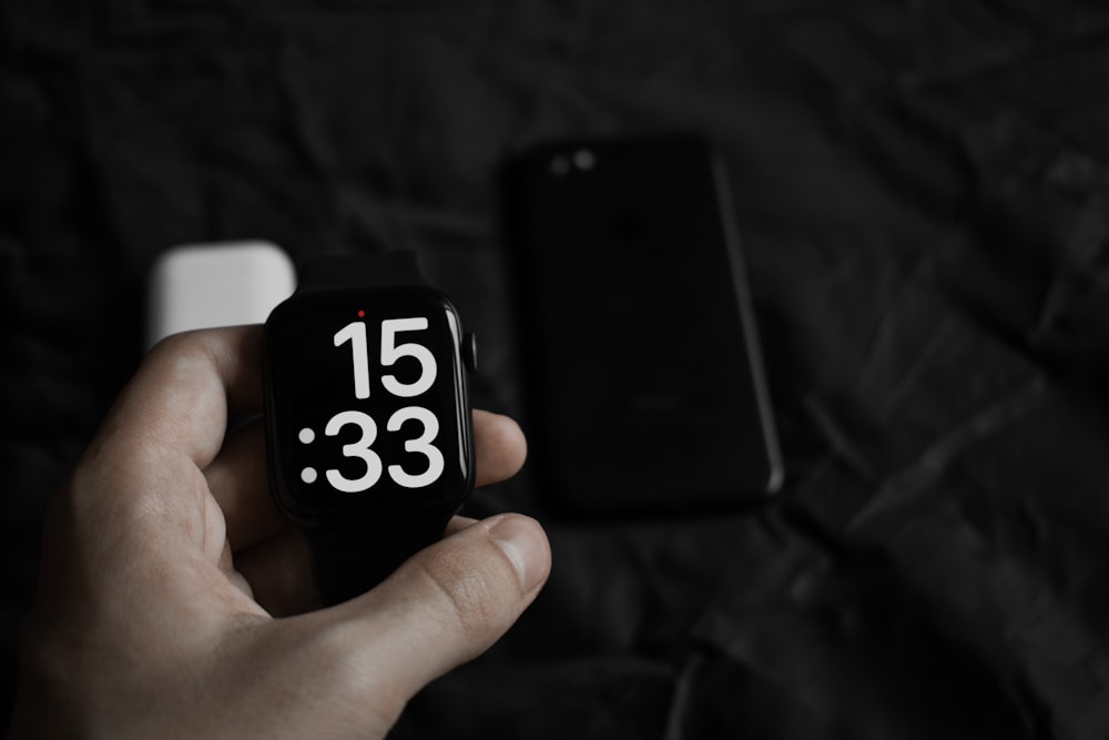 a hand holding a black and white cube with a white and black logo