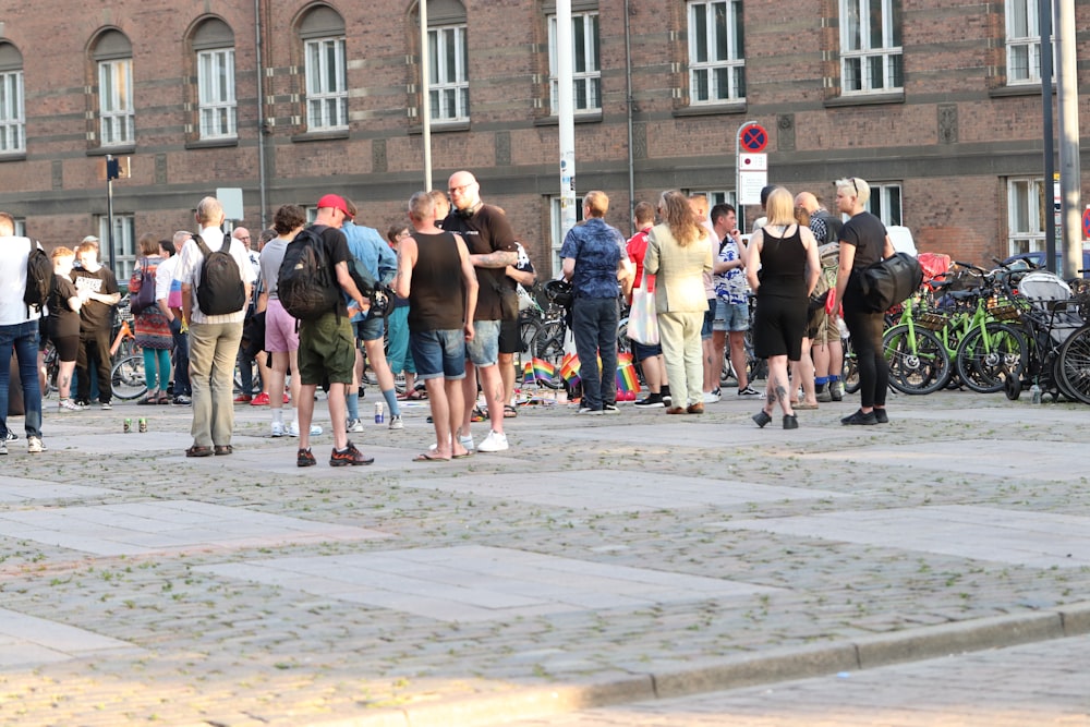 a group of people standing on a sidewalk