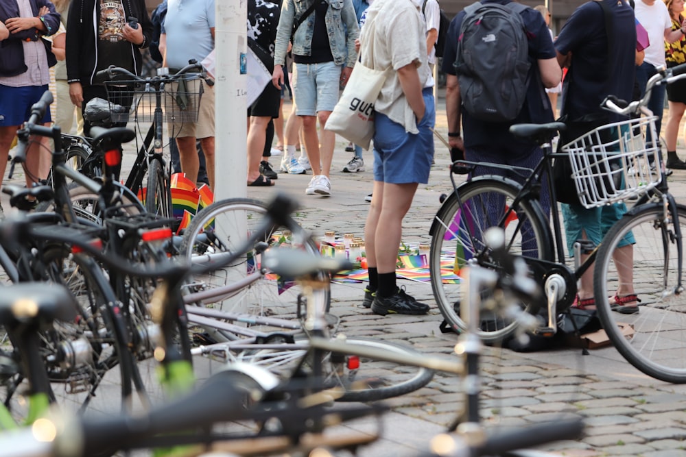 a group of people standing around bicycles