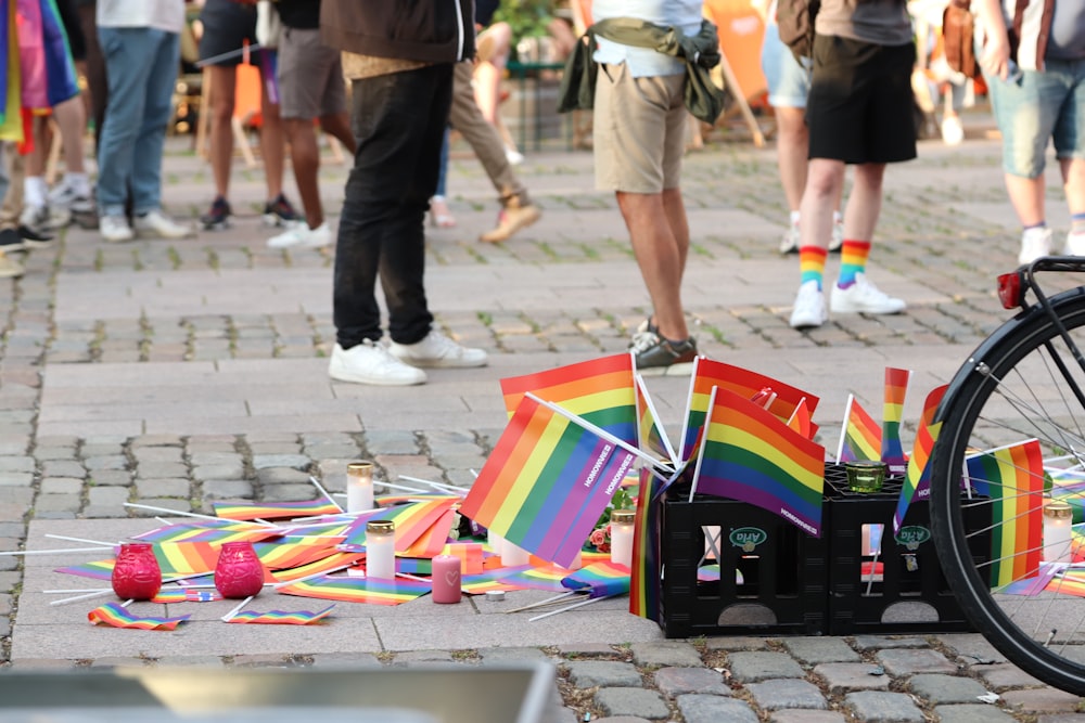 a group of people standing around a table with a colorful kite