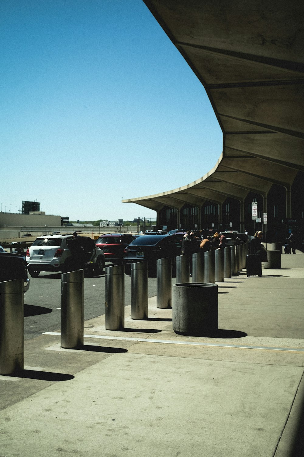 a parking lot with cars and a building in the background