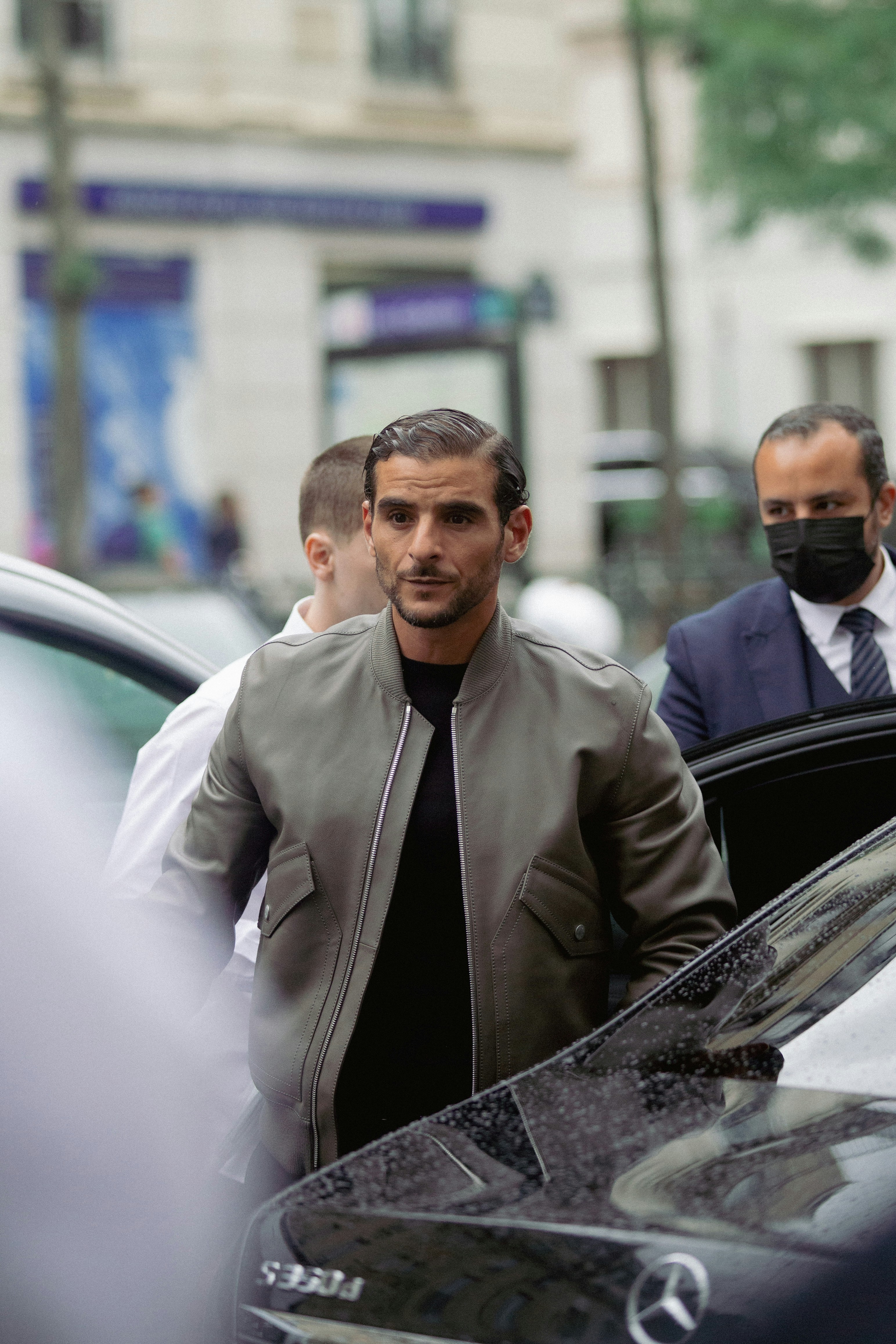 a man standing next to a car