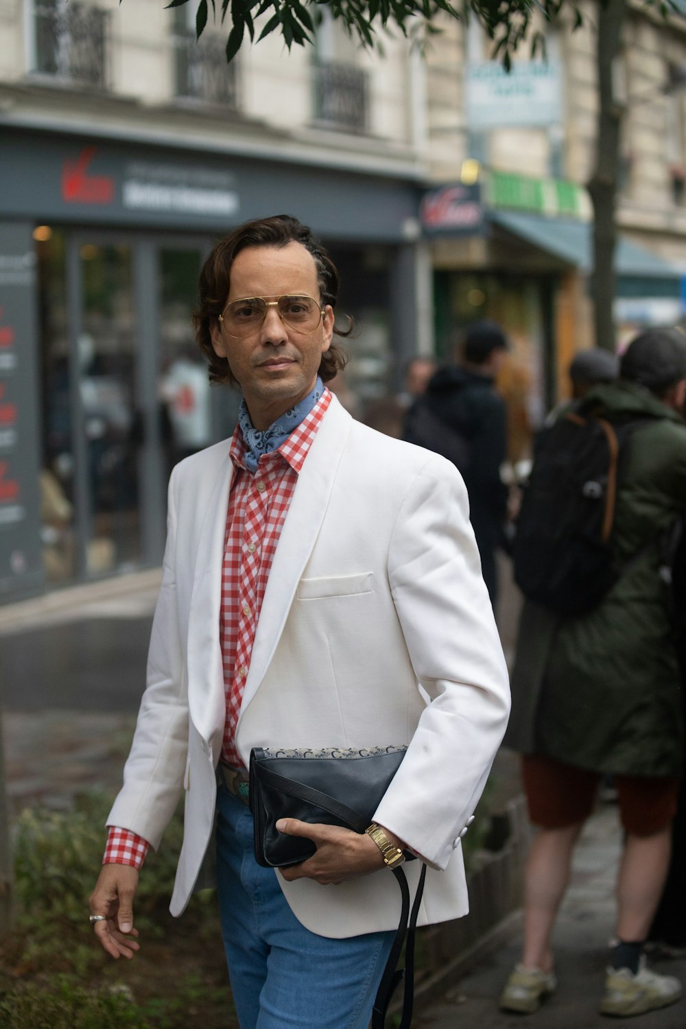 a man in a white coat and red tie