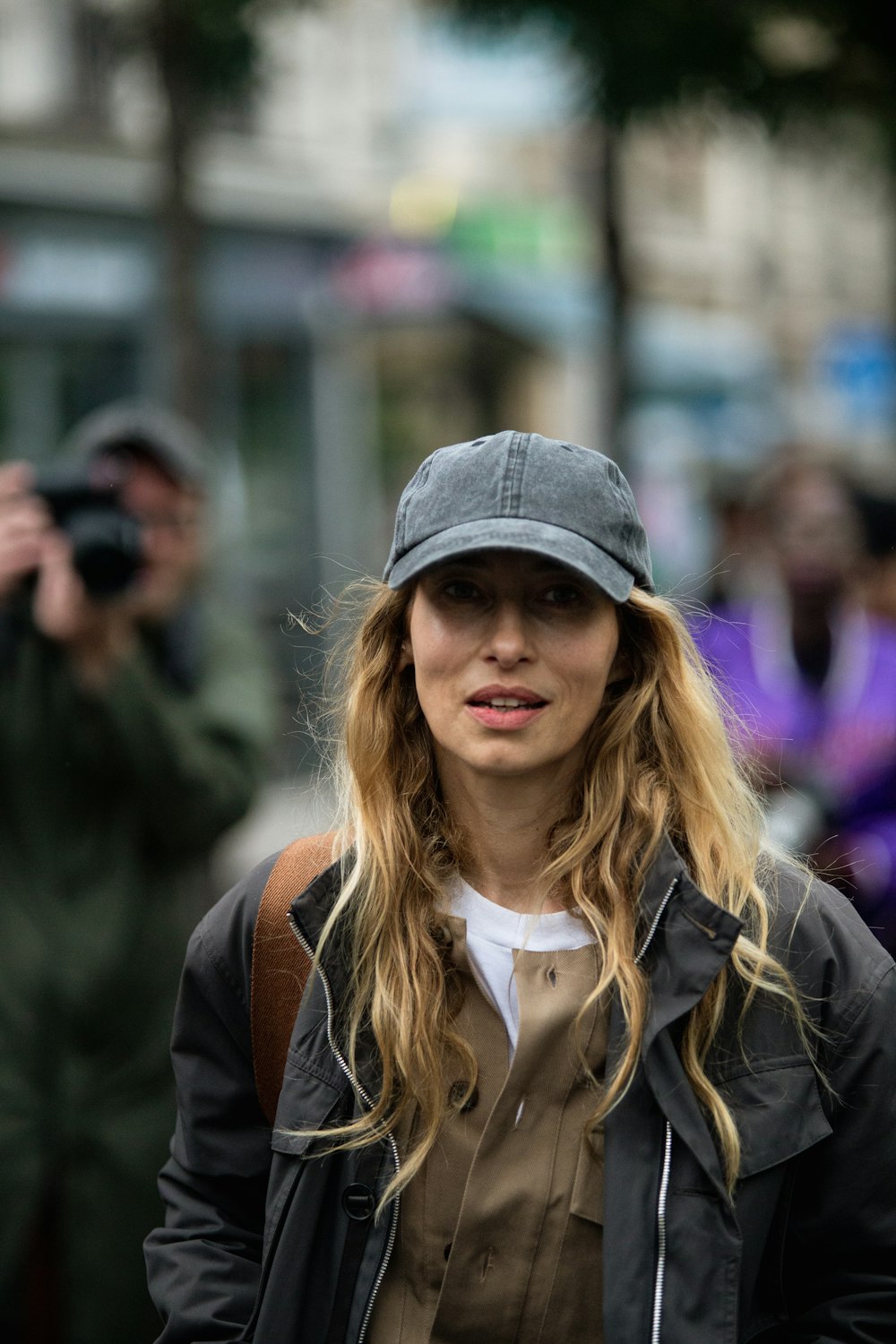 a woman with long hair and a hat