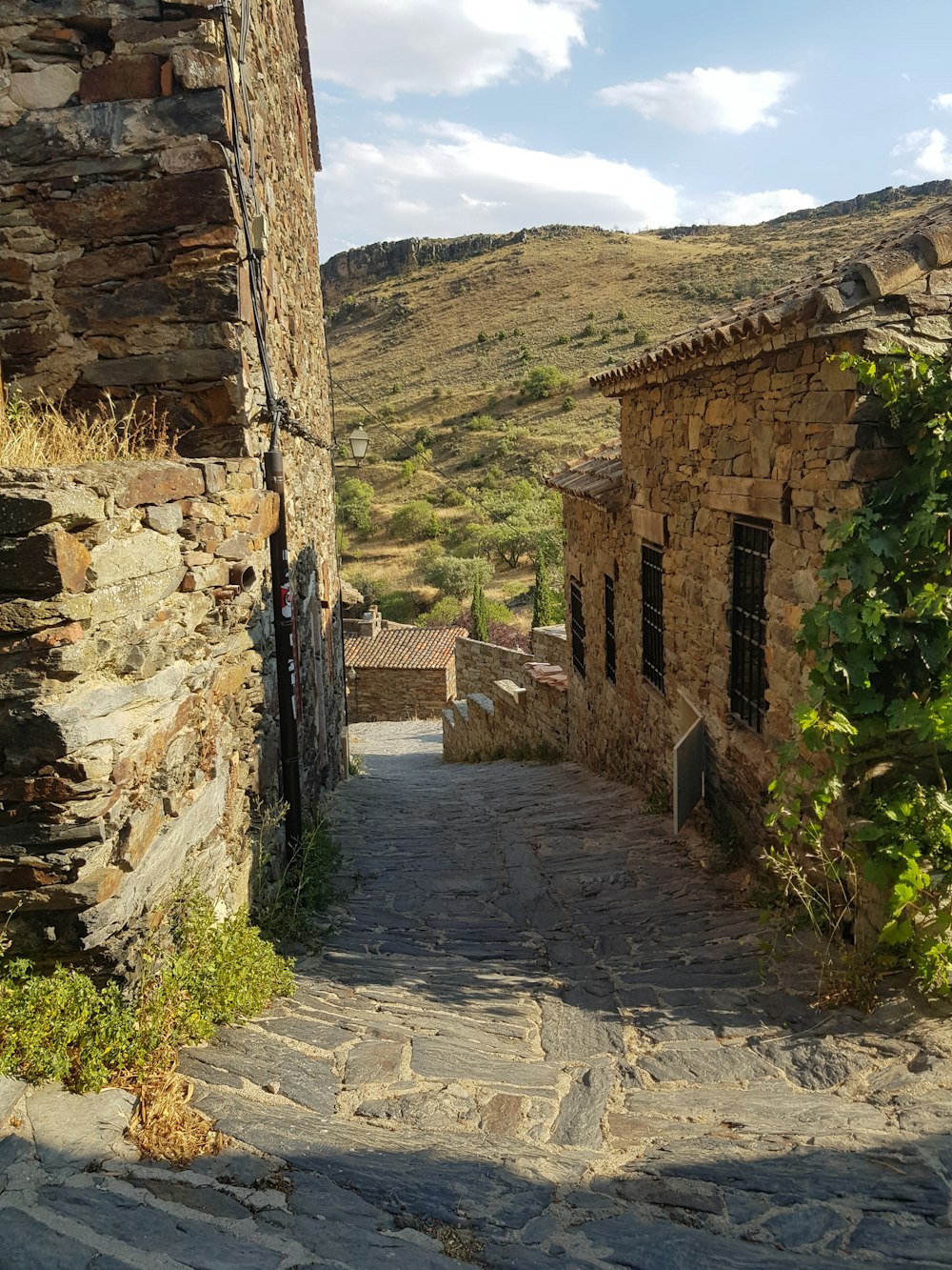 a stone road between stone buildings