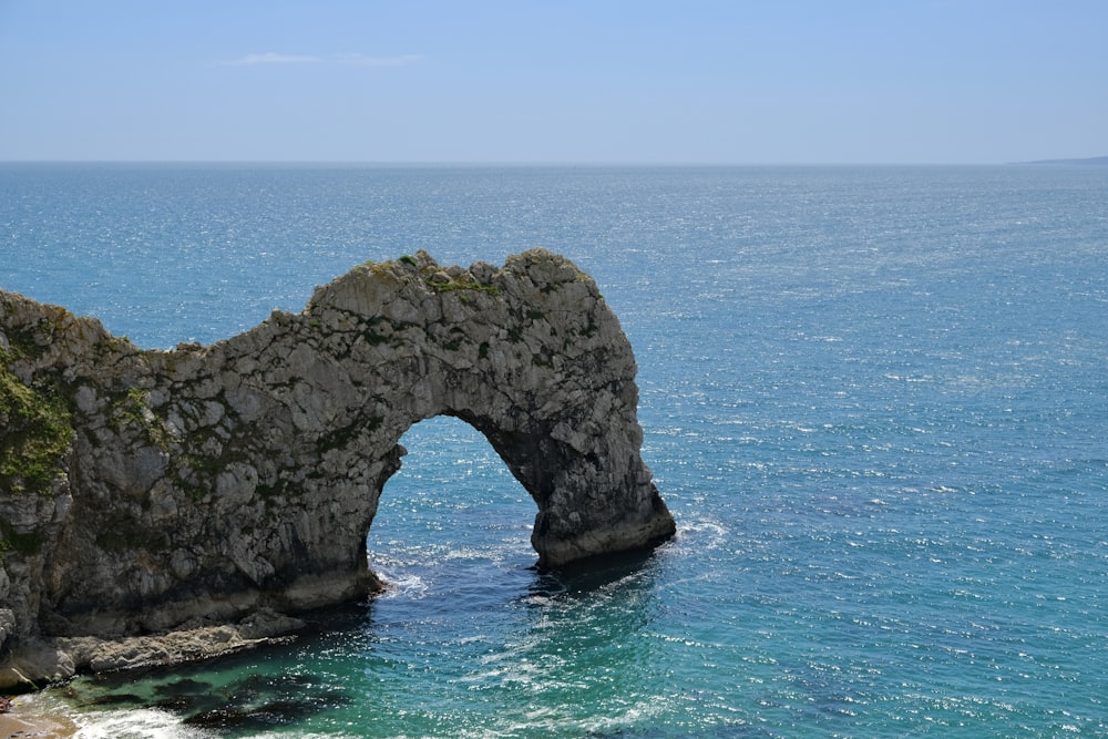 a rock arch in the water