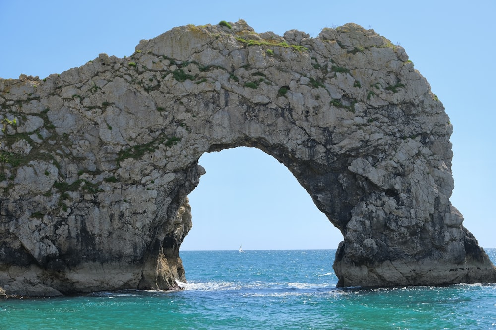 a large rock arch over the ocean