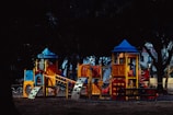 Happy children playing in the brightly colored playground area next to the pizzeria.
