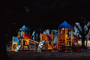 Team assembling a large playground set with bright slides and tunnels