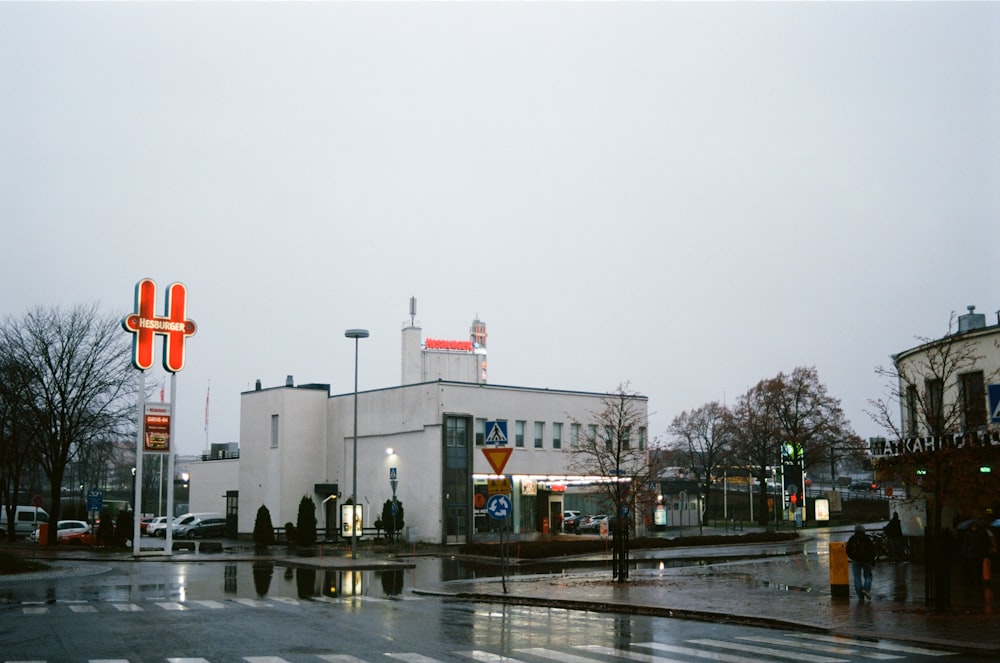 a wet street with a building in the background