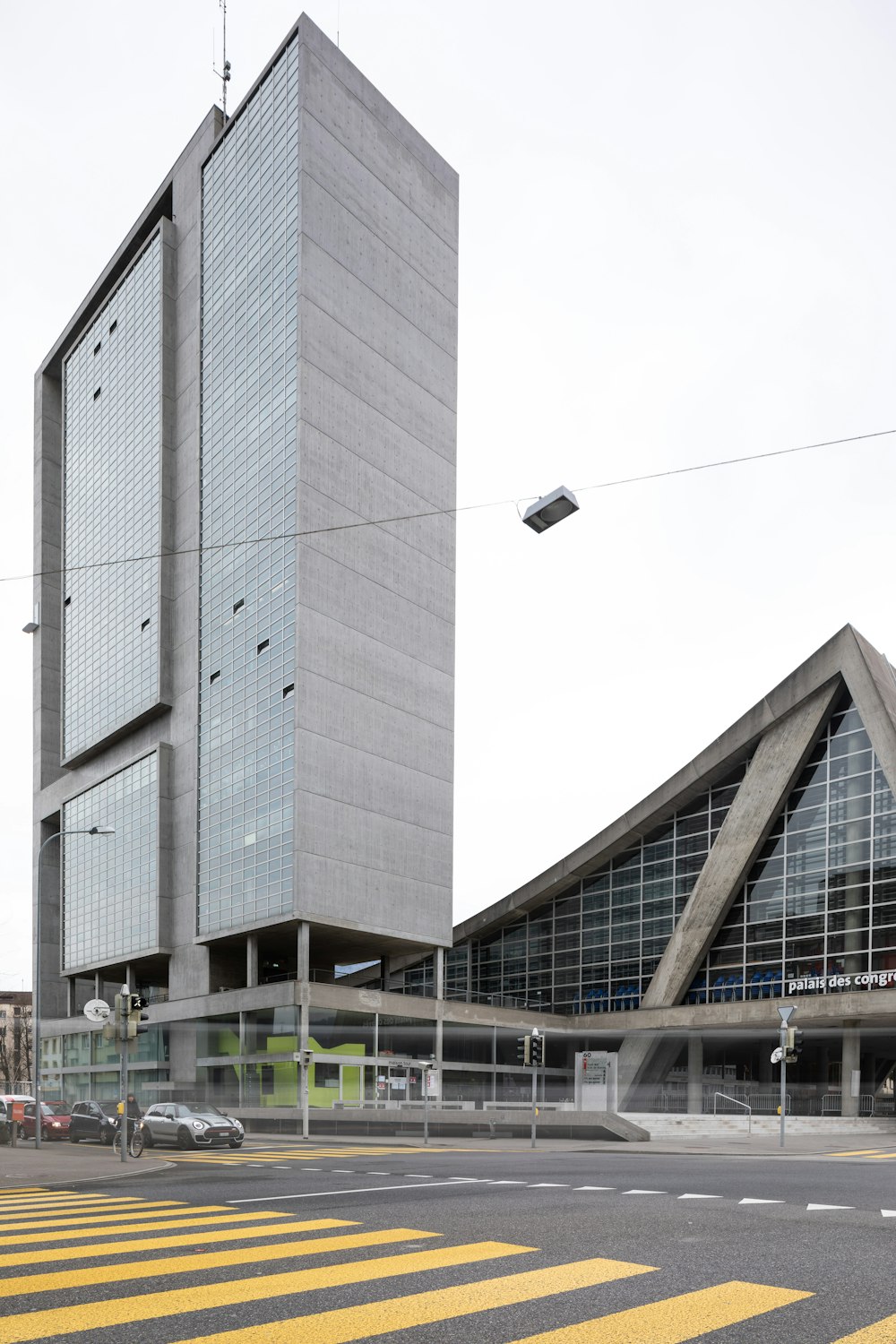 a tall building with a parking lot