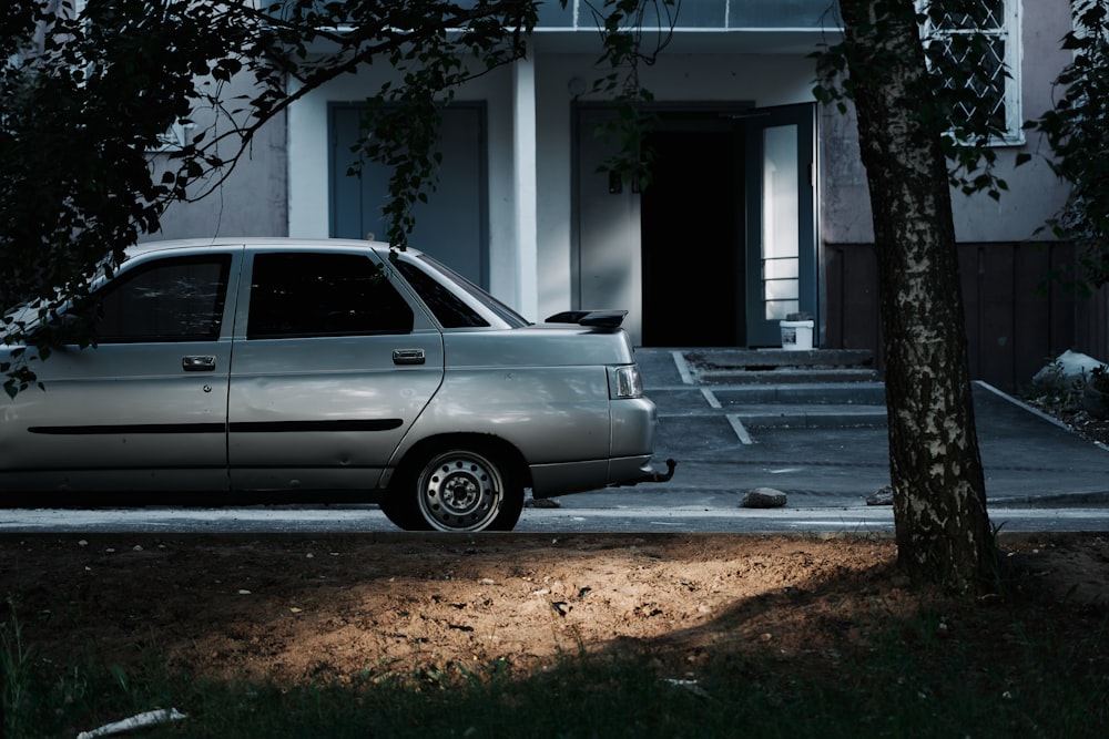 a silver car parked in front of a house