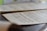 A close-up photo of sheet music pages spread out on a wooden table.