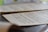 A close-up view of sheet music resting on a surface, with musical notes and symbols clearly visible. The background is softly blurred, drawing attention to the details of the musical notation.