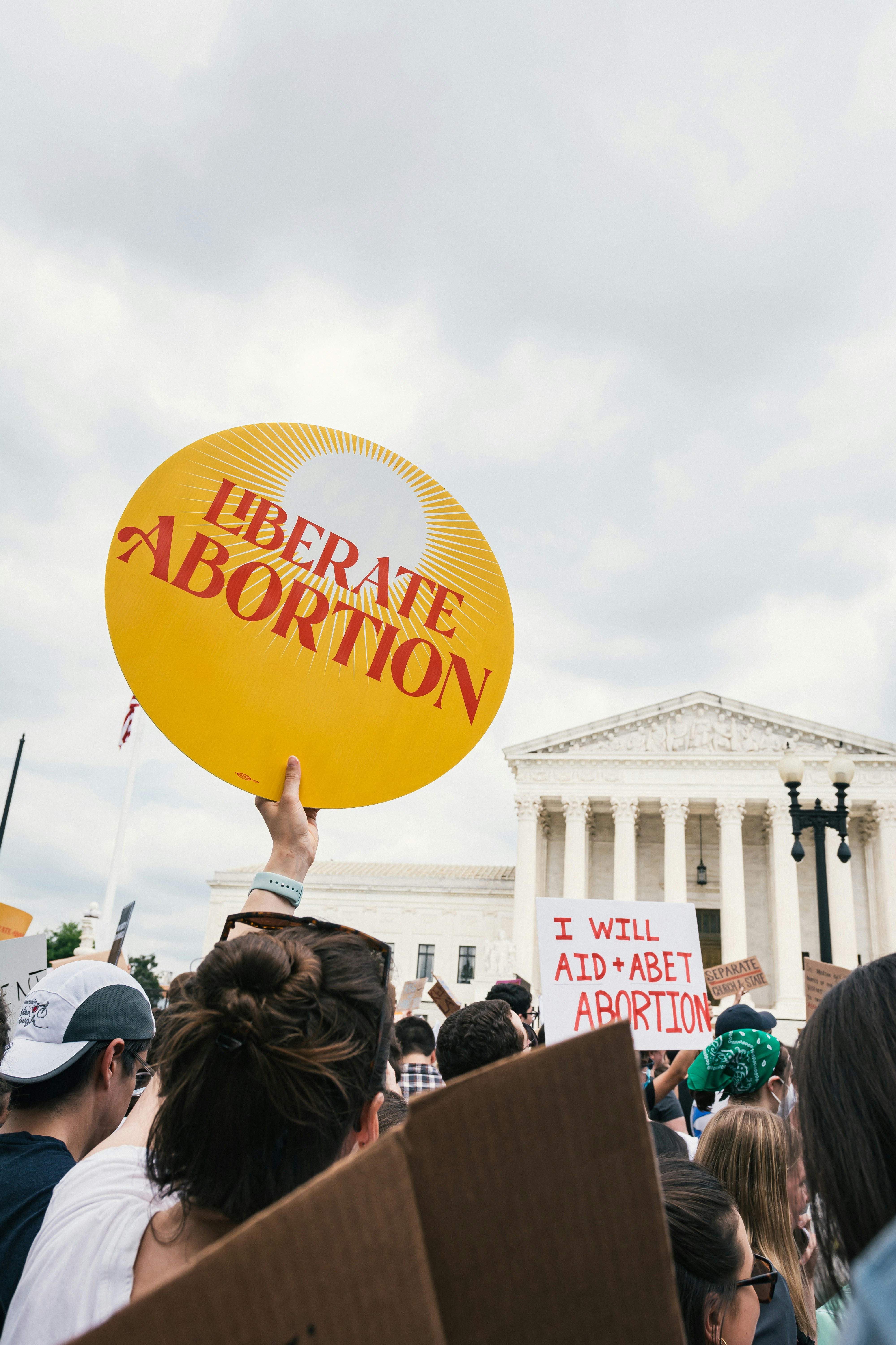 a crowd of people outside a white building