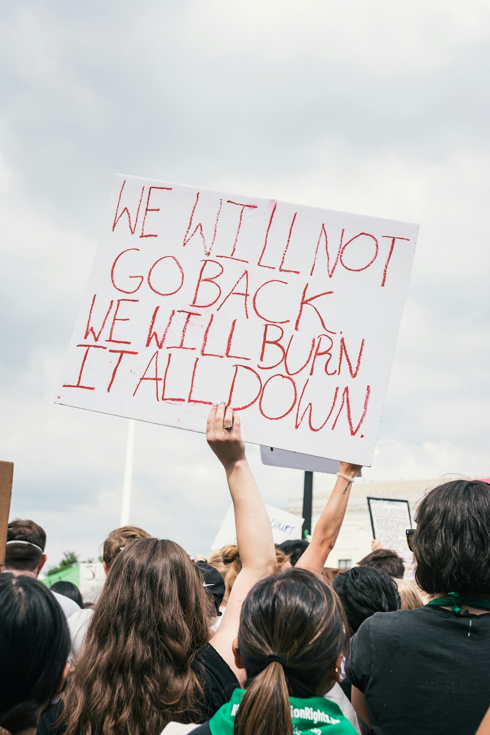 a group of people holding up a sign