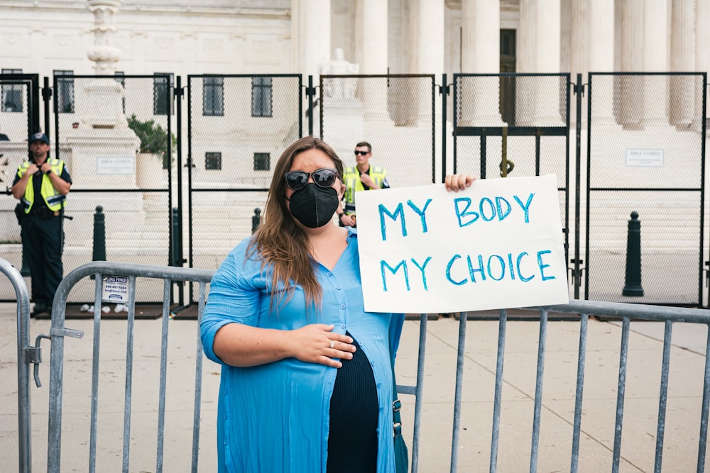 a couple of women holding a sign