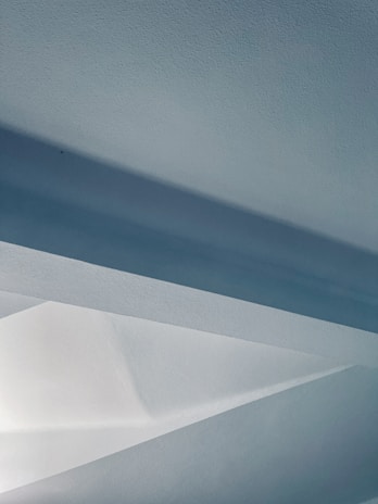 A serene modern art installation featuring soft blue and white tones, reflecting the brand's color palette.