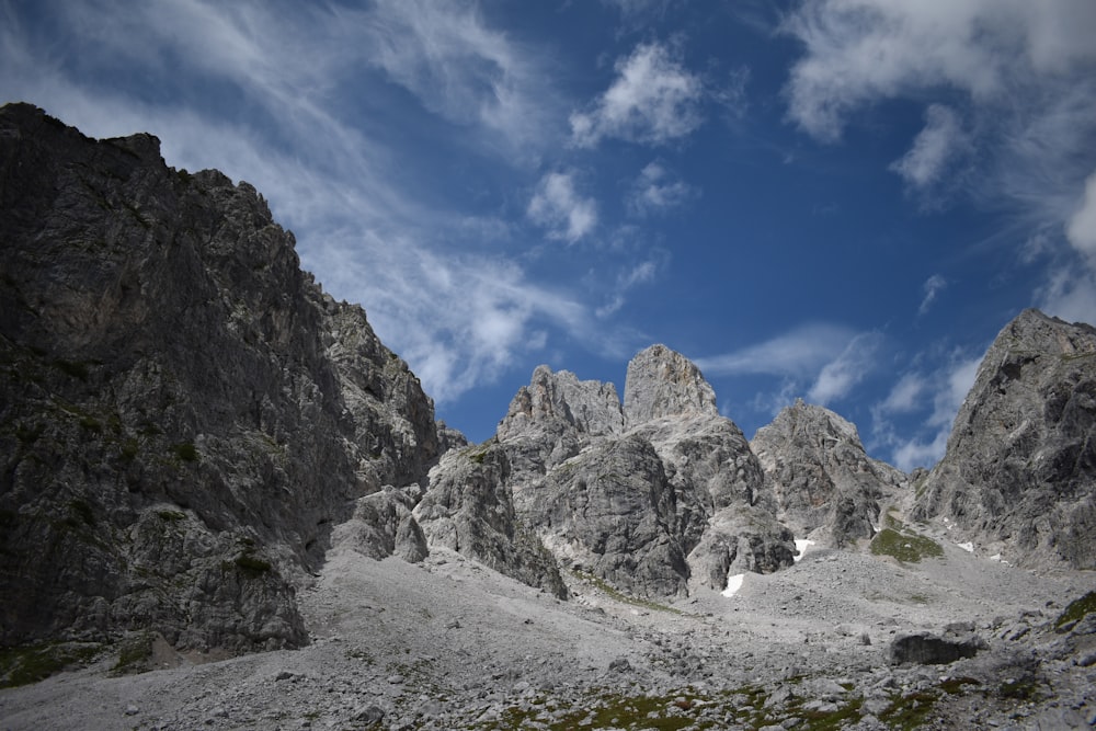 a rocky mountain with a blue sky