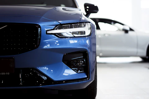 a blue car with a black headlight