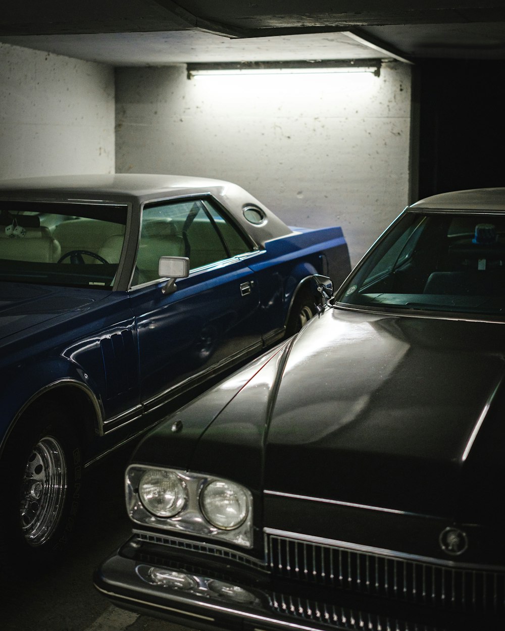 a couple of cars parked in a garage