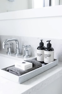 Theo — soft-lit morning skincare flat-lay on linen