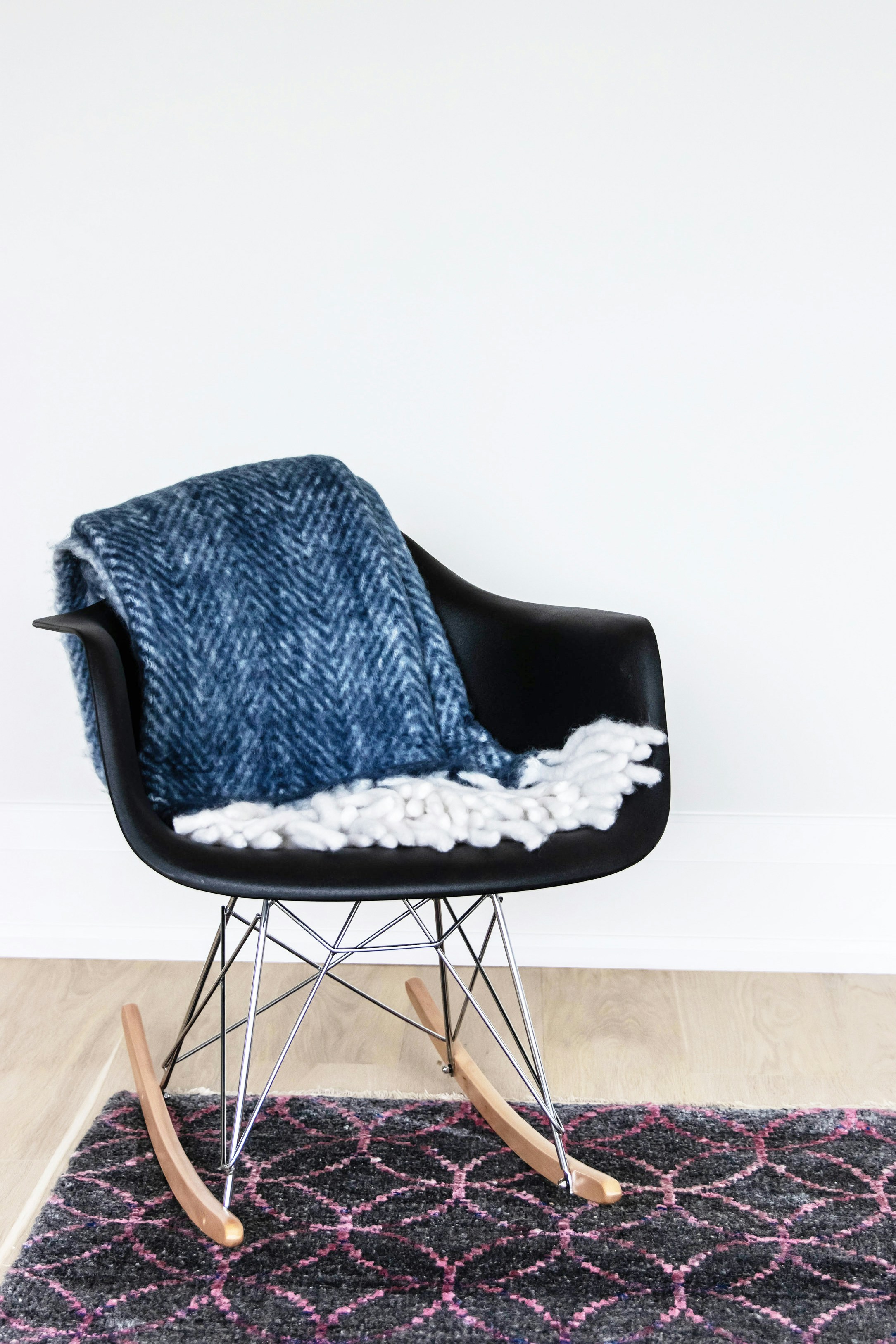 a black chair with a white blanket