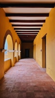 Sunlit hallway with classic herringbone parquet highlighting natural wood grains.