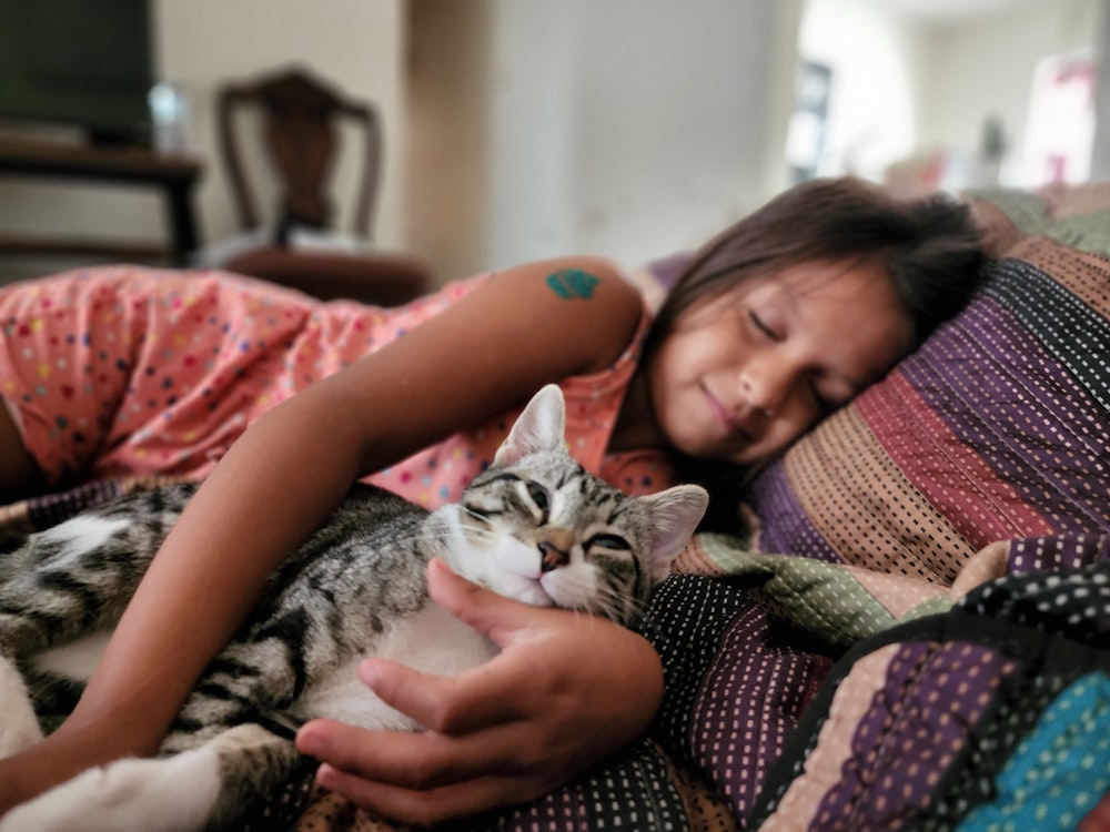 a woman lying on a couch with a cat