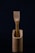 A wooden fork is elegantly placed inside a matching wooden container. The background is dark, emphasizing the natural texture and simplicity of the design.