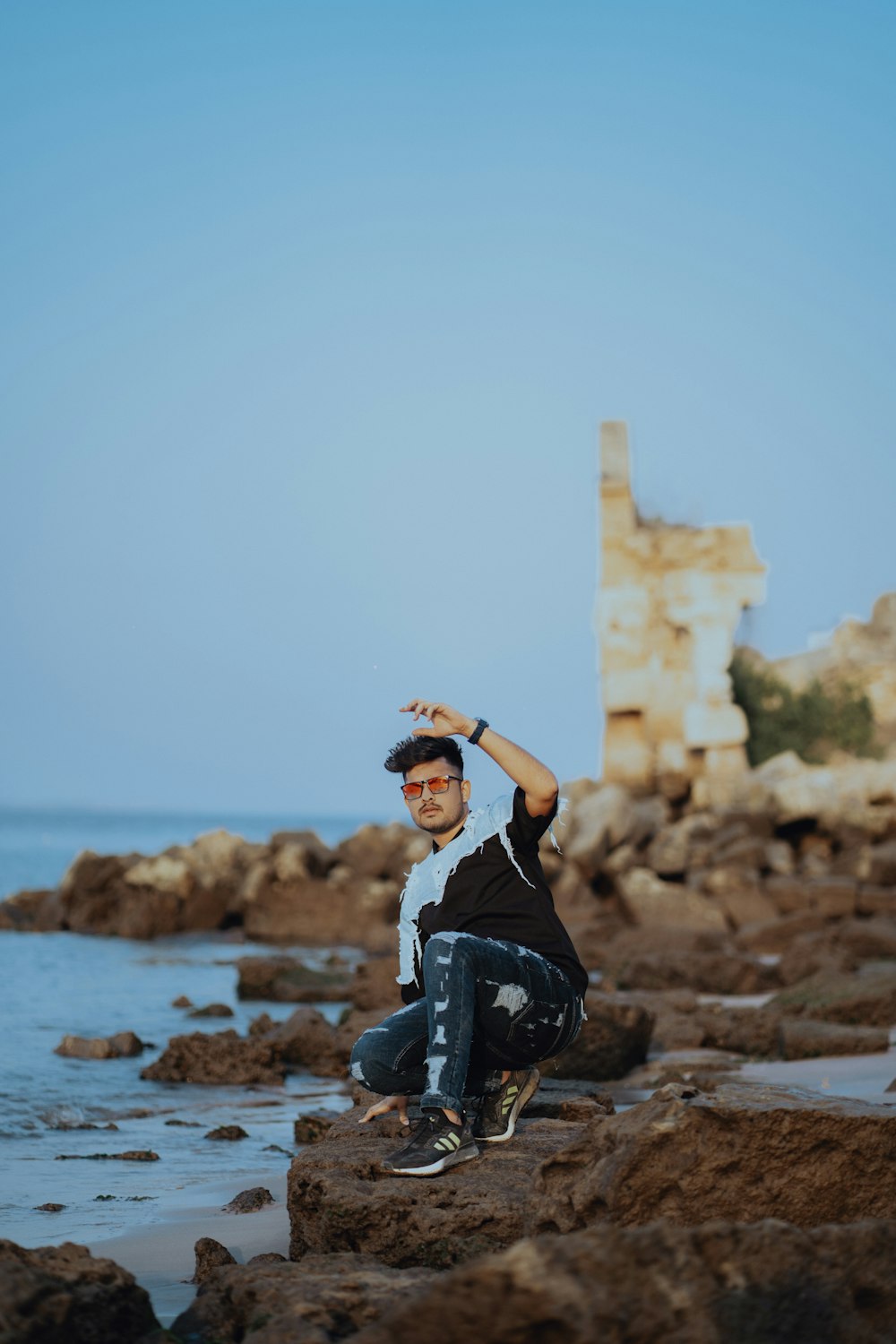 a man posing on a rock