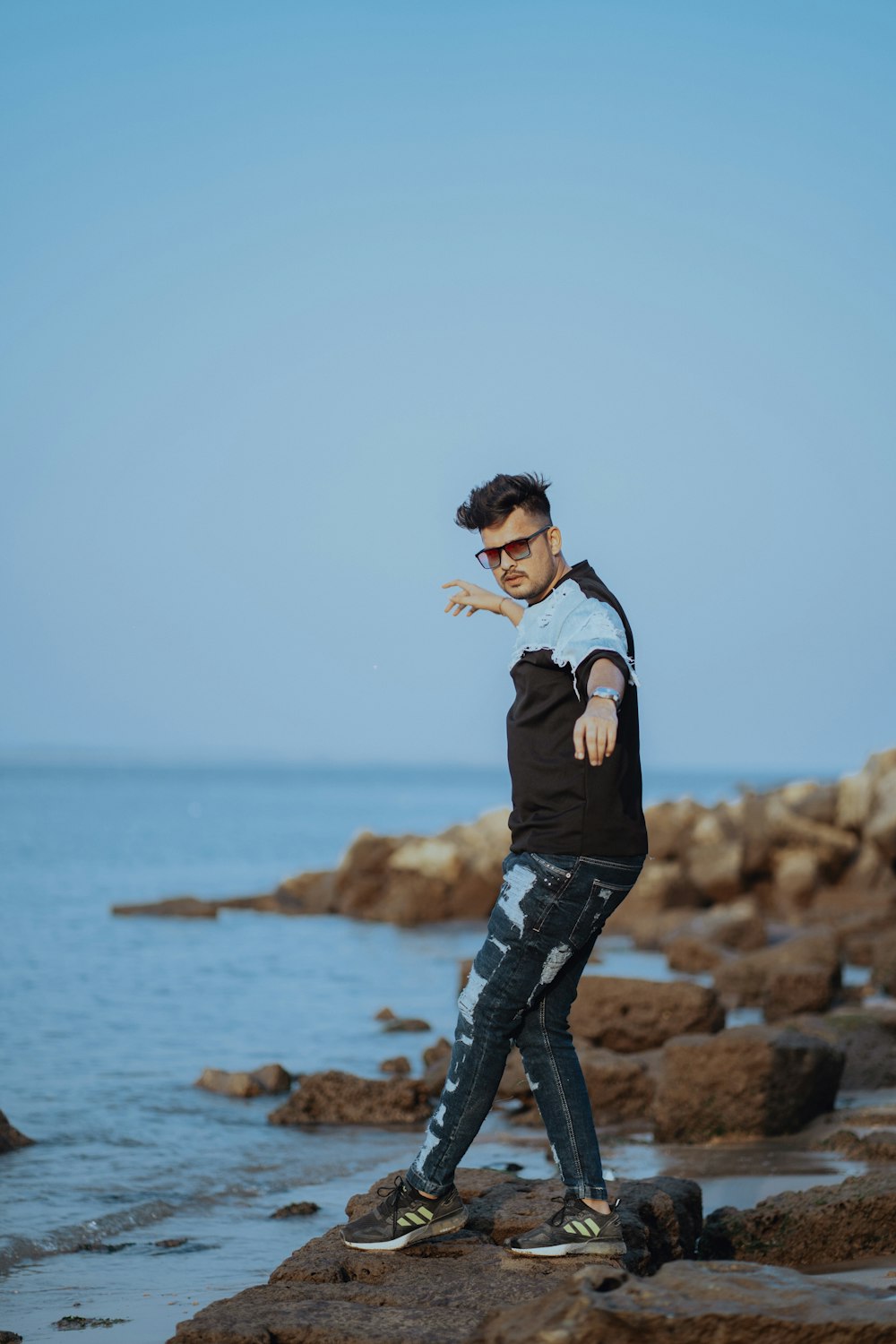 a man standing on a rocky beach