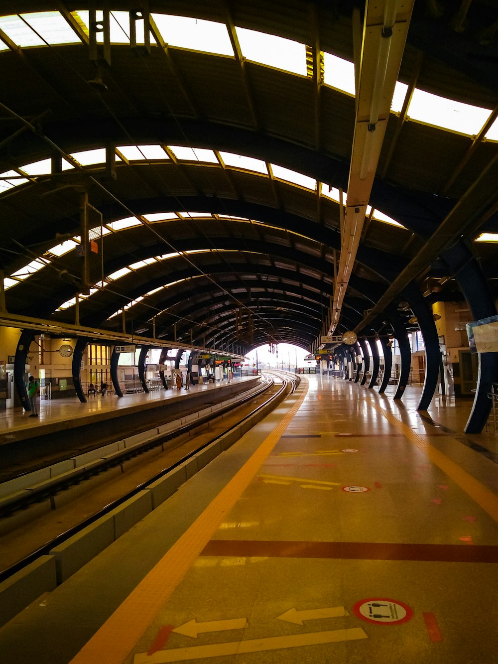 a train station with a yellow line